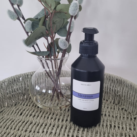 Bottle with a label next to a plant on a textured surface
