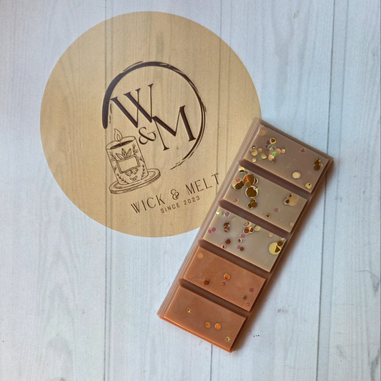 wax melts with decorative elements on a wooden board with 'Wick & Melt' branding.